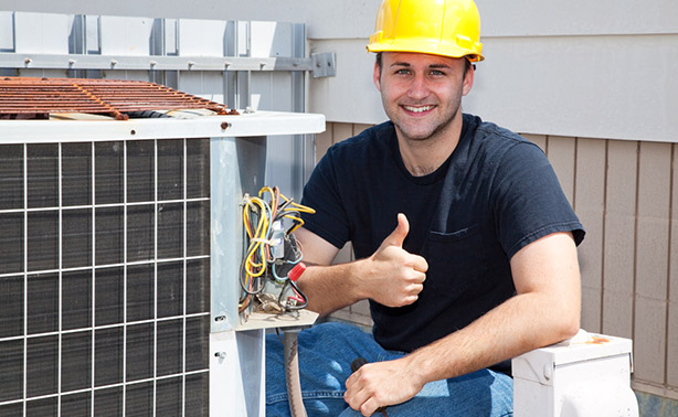 Twin City Service technician giving a thumbs up after an HVAC service call